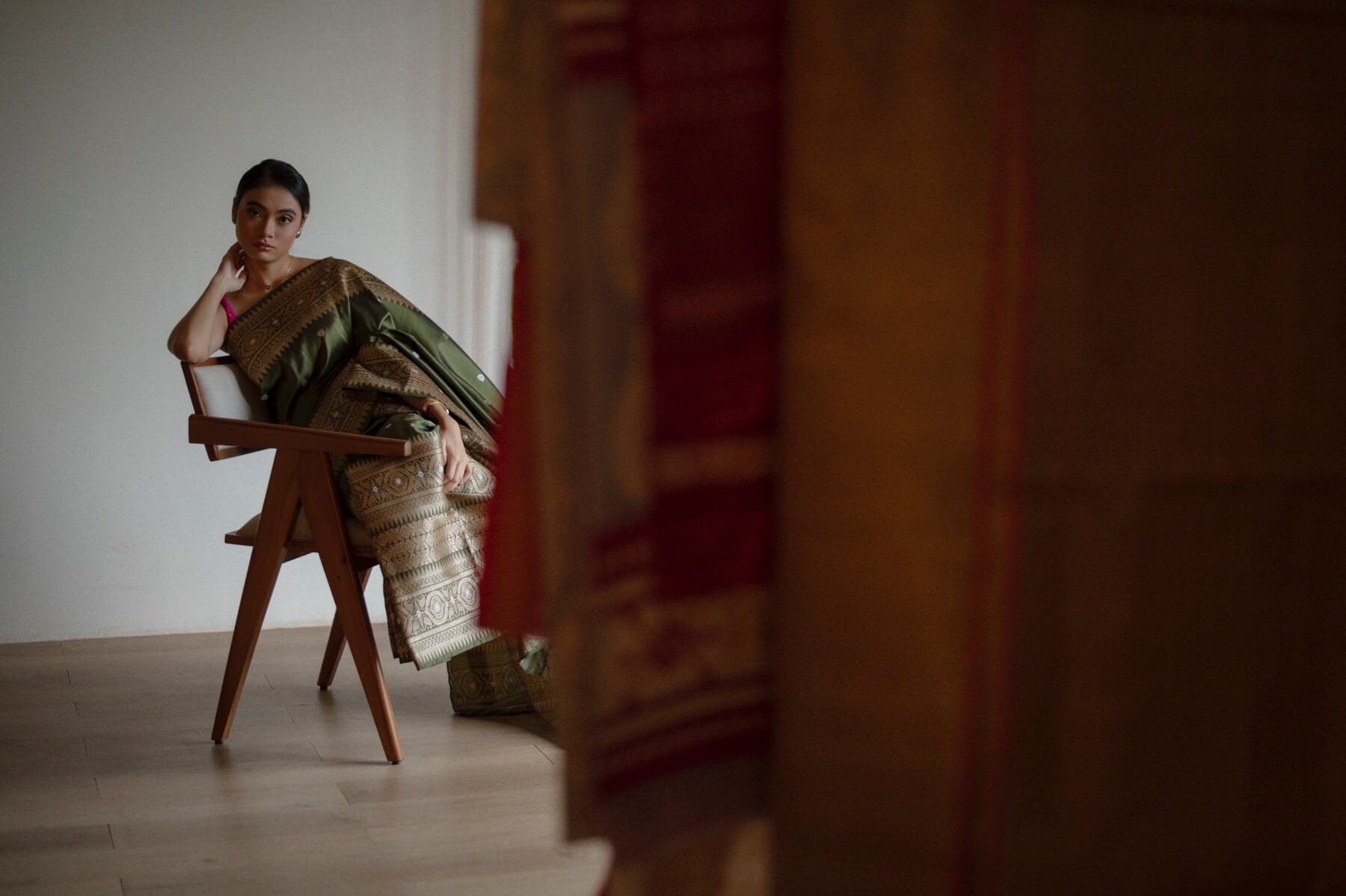 Model sitting on chair wearing a mekhela sador