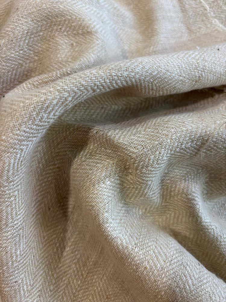 A close-up view of red Eri silk twill fabric with a textured, denim-like appearance.