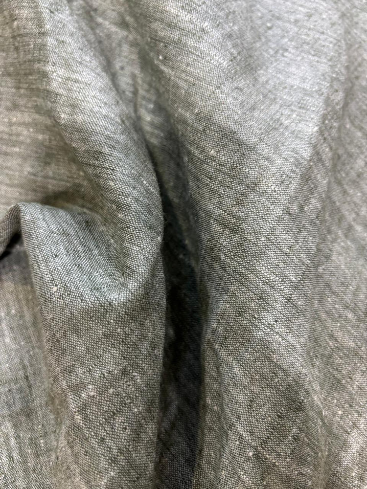 A close-up of draped gray fabric with a textured, slightly lustrous weave.