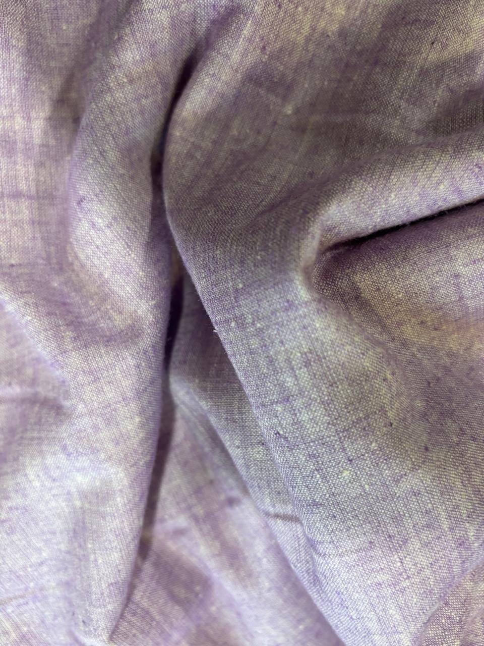 A close-up of draped lavender-purple fabric with a soft, slightly textured weave.