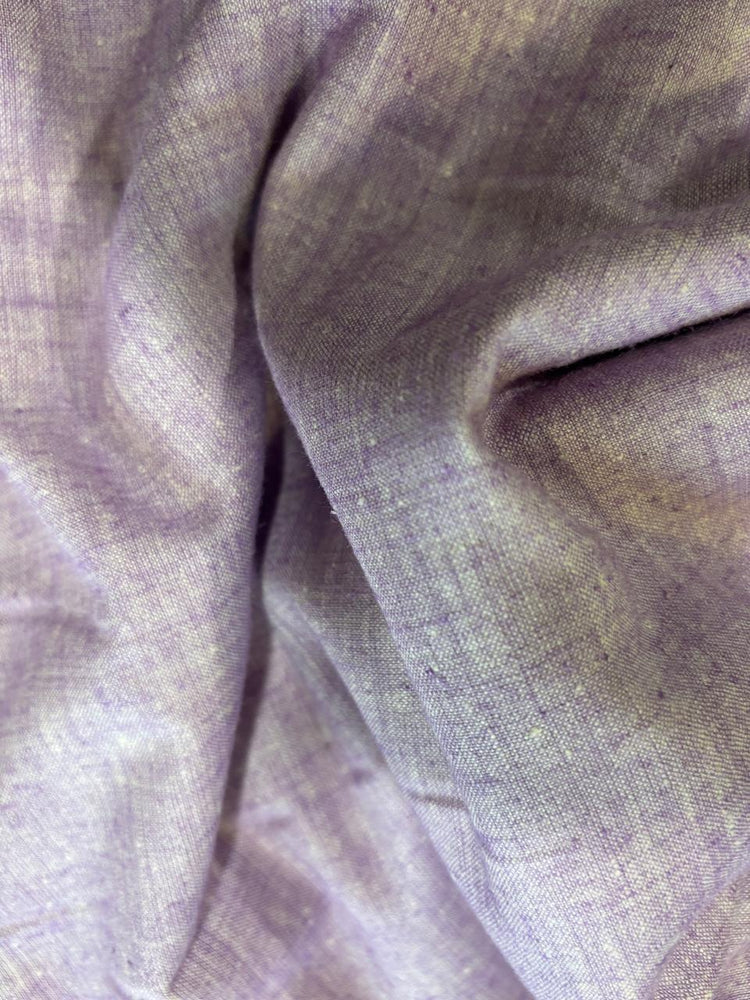A close-up of draped lavender-purple fabric with a soft, slightly textured weave.