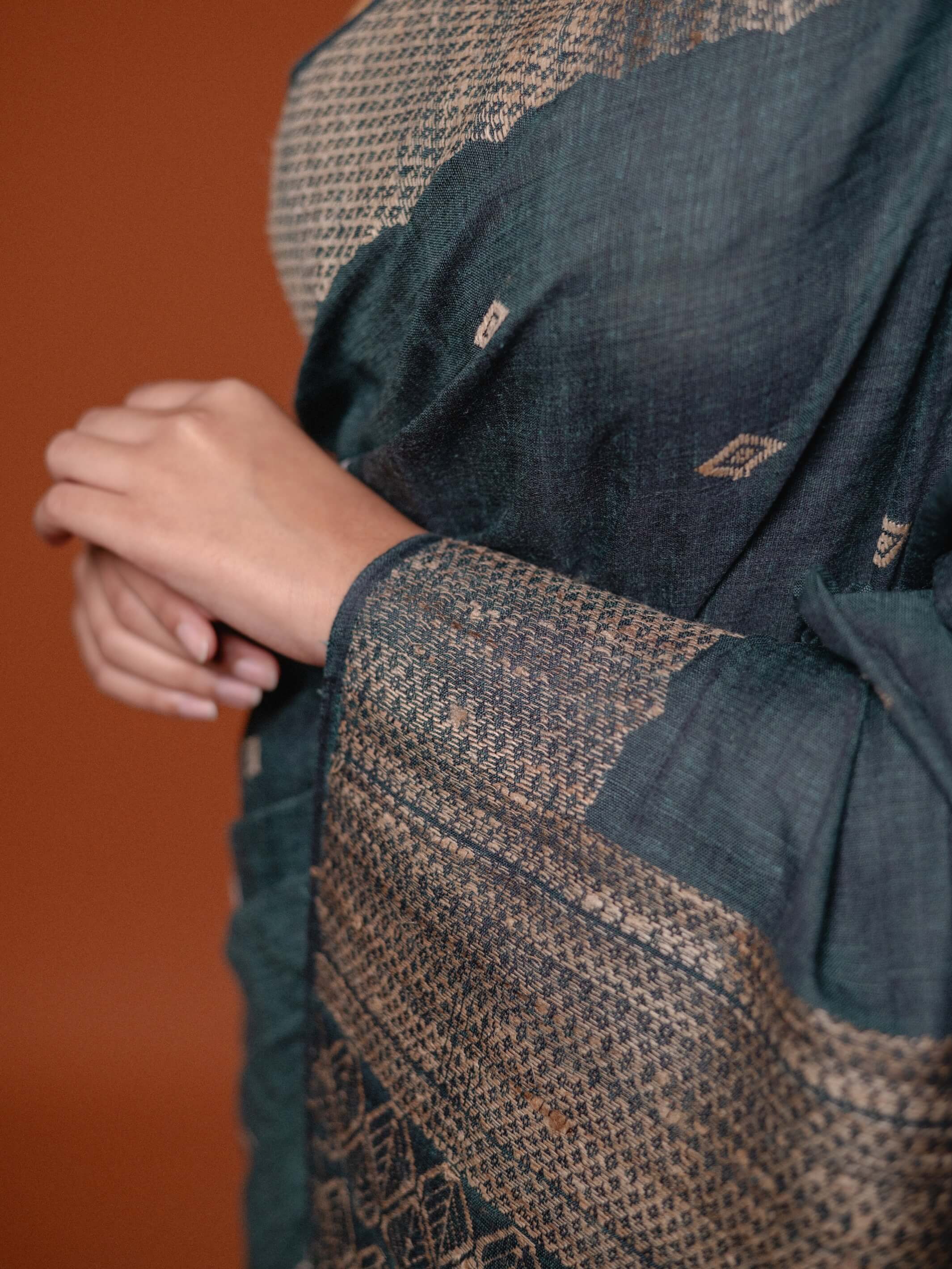 Close-up of a textured fabric with a patterned design on a brown background