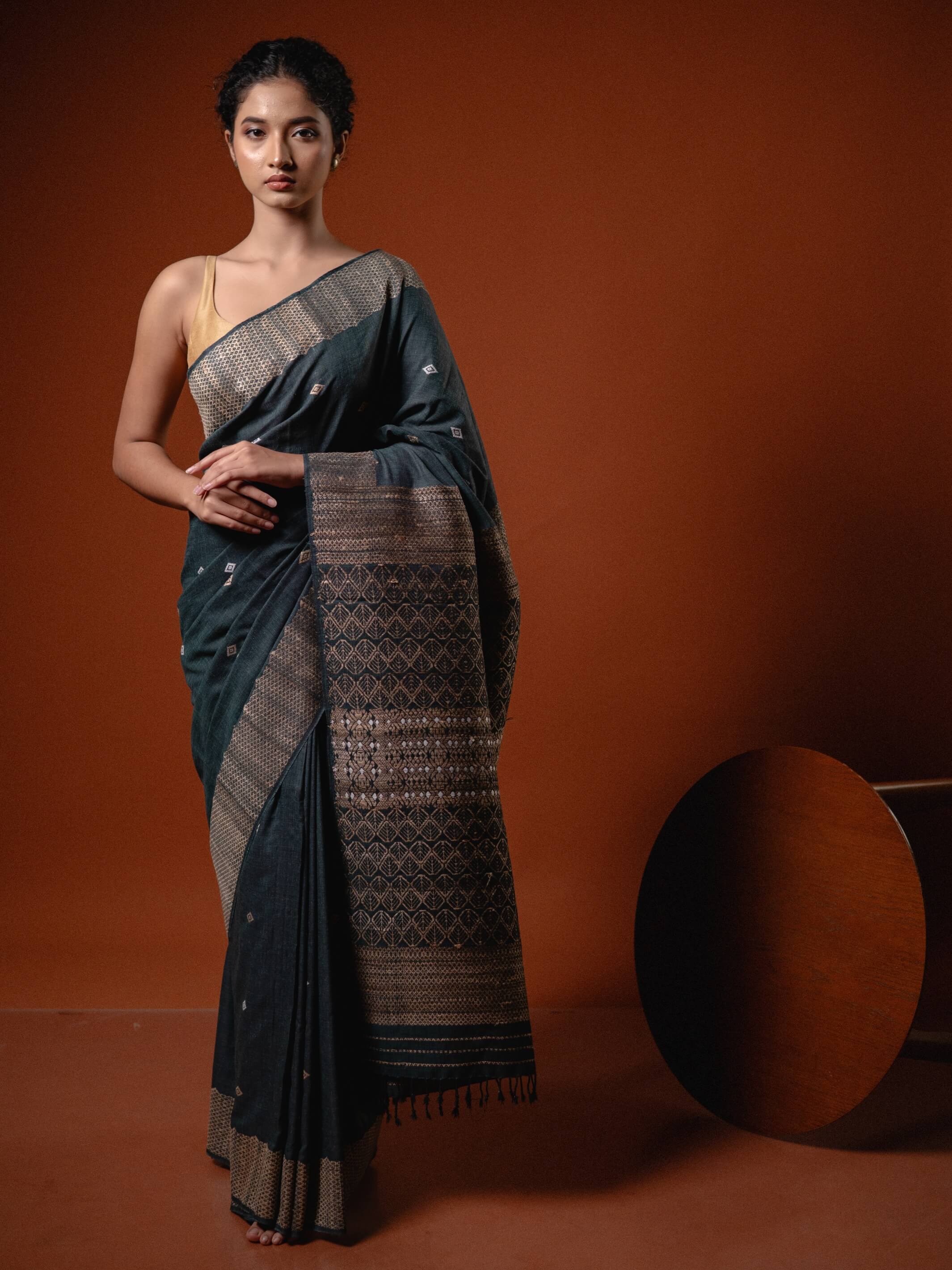 Woman wearing a traditional saree with a brown background